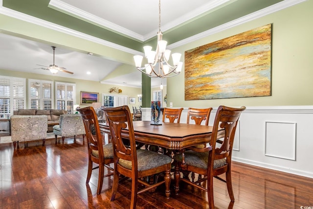 dining space with dark hardwood / wood-style flooring, ceiling fan with notable chandelier, and ornamental molding