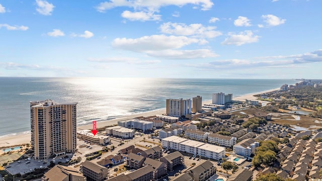 drone / aerial view with a water view and a beach view