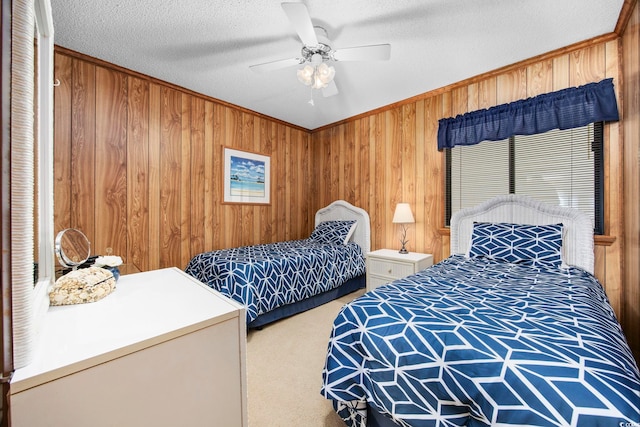 bedroom featuring carpet, a textured ceiling, ceiling fan, and wood walls