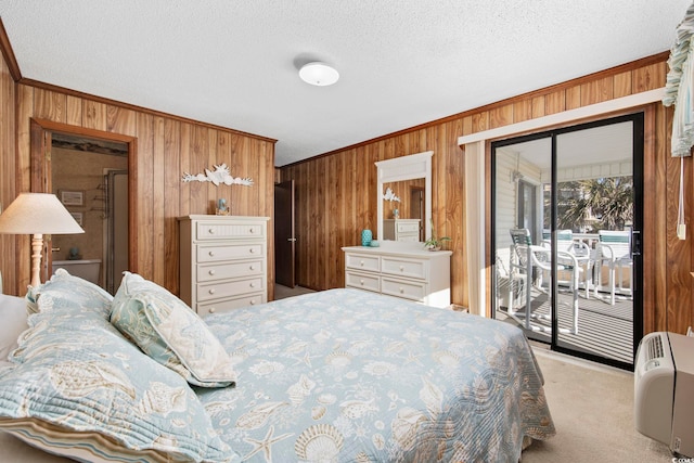 carpeted bedroom featuring access to exterior, wood walls, crown molding, and a textured ceiling