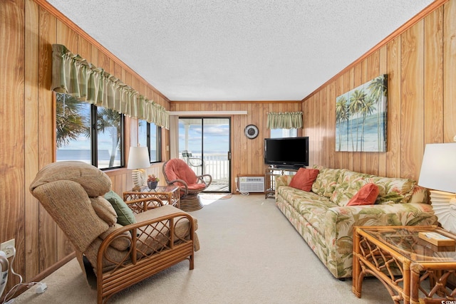 carpeted living room with wooden walls, a textured ceiling, and ornamental molding