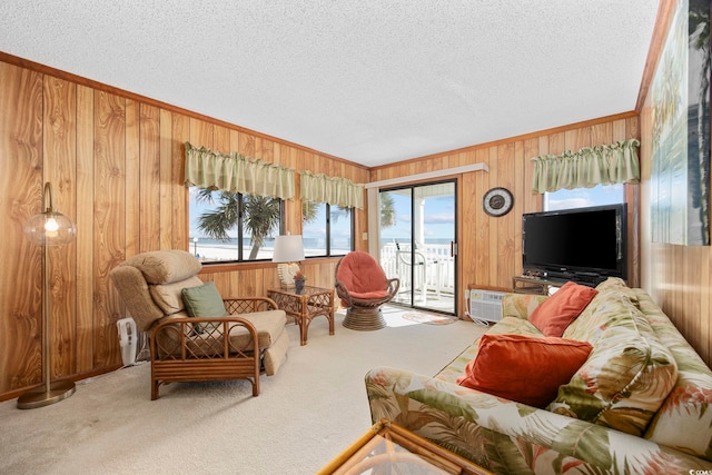 living room with wood walls, light colored carpet, an AC wall unit, and a textured ceiling