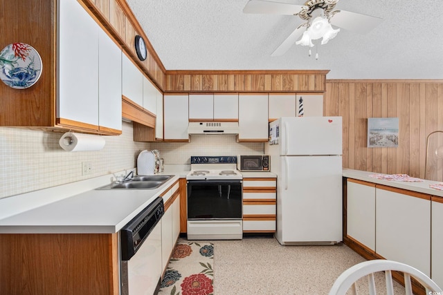 kitchen featuring white cabinets, white appliances, sink, and a textured ceiling