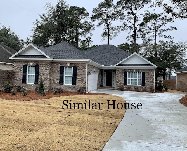 93 Pintail Ct, Pawleys Island, SC 29585 - view of front of home with a garage, concrete driveway, roof with shingles, and brick siding