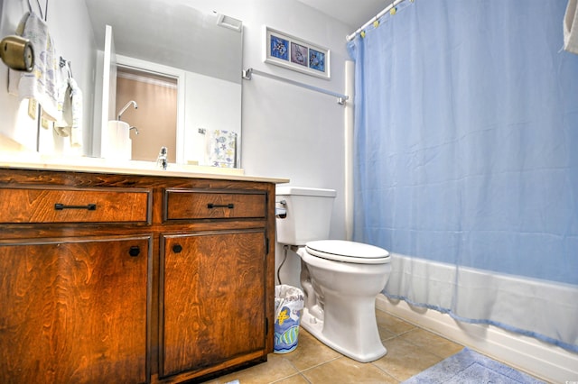 bathroom with tile patterned flooring, vanity, and toilet