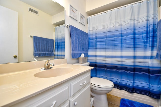 full bathroom with tile patterned floors, shower / tub combo with curtain, vanity, and toilet