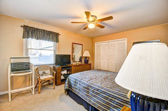 carpeted bedroom featuring a closet and ceiling fan