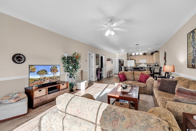 living room with crown molding, ceiling fan, and light wood-type flooring