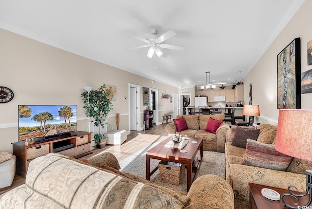 living room featuring ceiling fan and ornamental molding