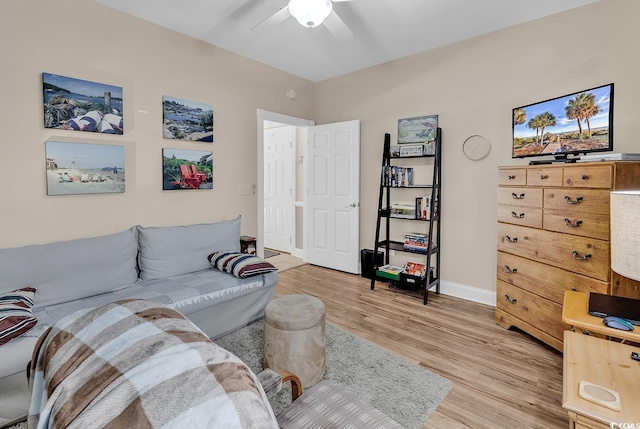 living room with ceiling fan and light wood-type flooring