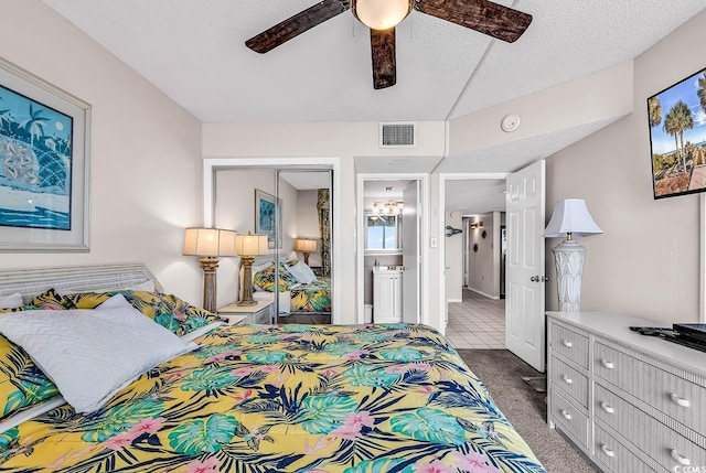 carpeted bedroom featuring a textured ceiling, a closet, and ceiling fan