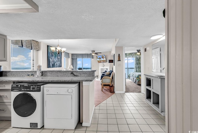 kitchen featuring plenty of natural light, light tile patterned flooring, and washer / dryer