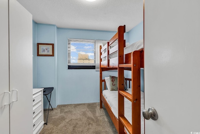 bedroom featuring a textured ceiling and carpet floors