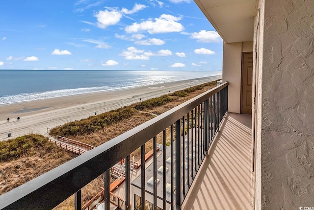 balcony with a water view and a beach view
