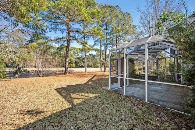 view of yard with glass enclosure