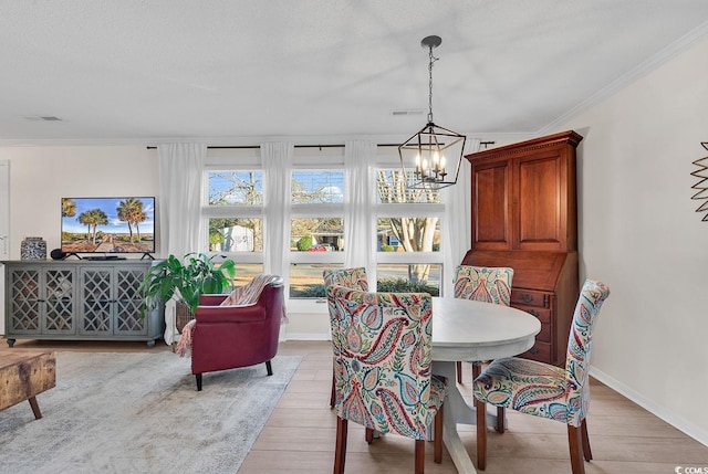 dining space with plenty of natural light, ornamental molding, and light hardwood / wood-style floors