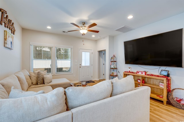 living room with ceiling fan and wood-type flooring