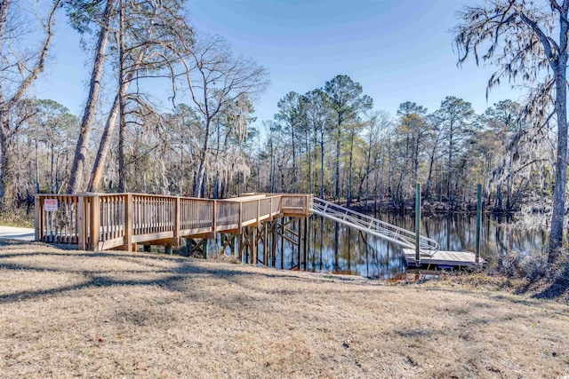 dock area with a water view and a lawn