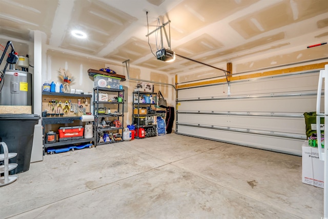 garage with water heater, a garage door opener, and a workshop area