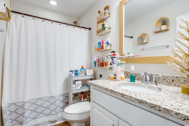 bathroom featuring toilet and vanity