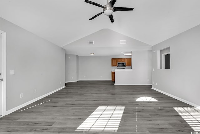 unfurnished living room featuring wood-type flooring, vaulted ceiling, and ceiling fan