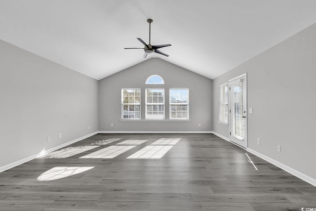 unfurnished room featuring ceiling fan, dark hardwood / wood-style flooring, and vaulted ceiling