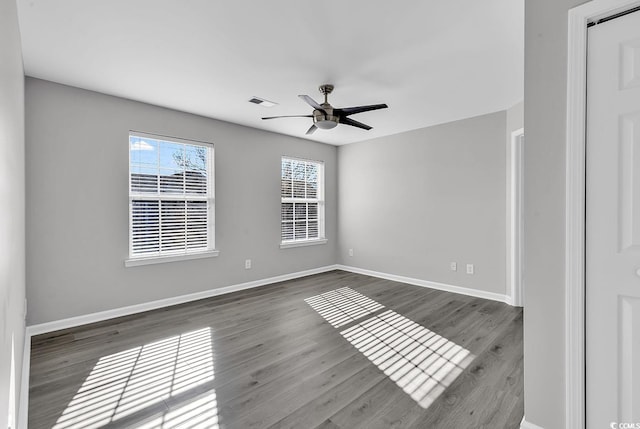 spare room featuring wood-type flooring and ceiling fan