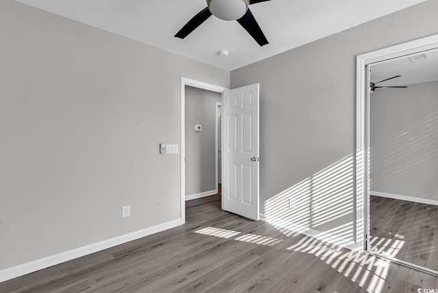 unfurnished bedroom featuring dark hardwood / wood-style flooring and ceiling fan