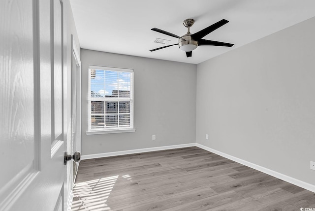 unfurnished room with light wood-type flooring and ceiling fan