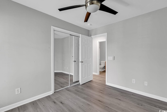 unfurnished bedroom featuring ceiling fan, light hardwood / wood-style flooring, and a closet