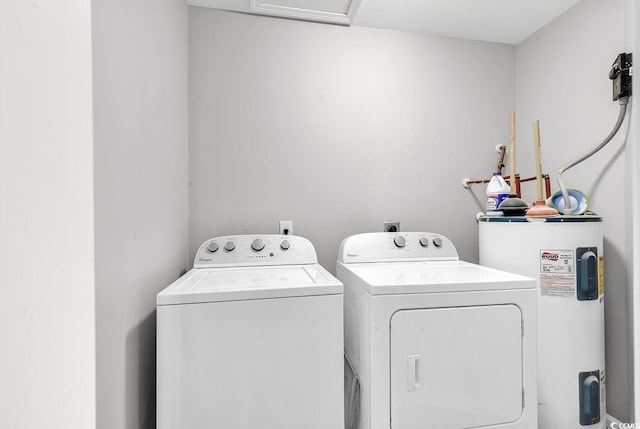 washroom with electric water heater and washer and dryer