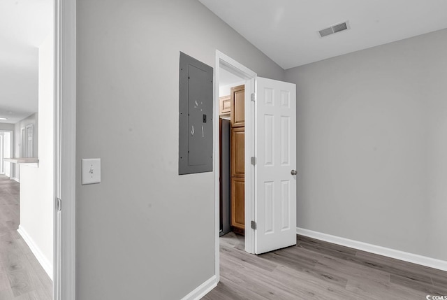 corridor featuring electric panel and light wood-type flooring