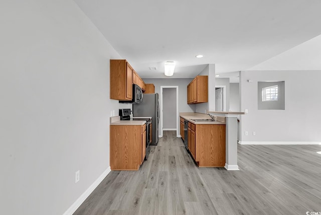 kitchen with range with electric cooktop, sink, light hardwood / wood-style flooring, black dishwasher, and kitchen peninsula