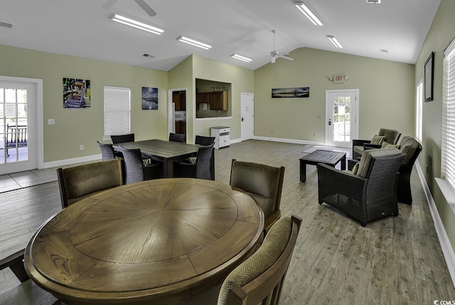 dining space with ceiling fan, a healthy amount of sunlight, and light wood-type flooring