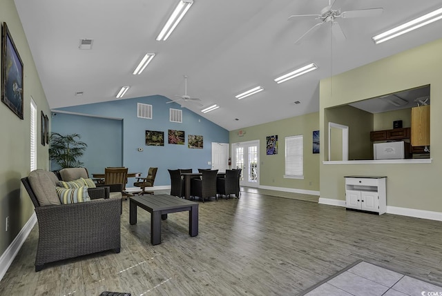 living room with ceiling fan, wood-type flooring, and lofted ceiling