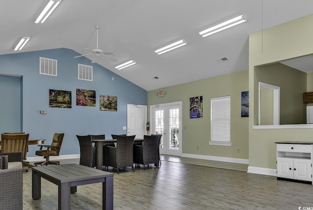 living room with ceiling fan, high vaulted ceiling, and dark hardwood / wood-style floors