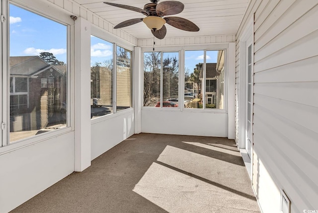 unfurnished sunroom featuring ceiling fan