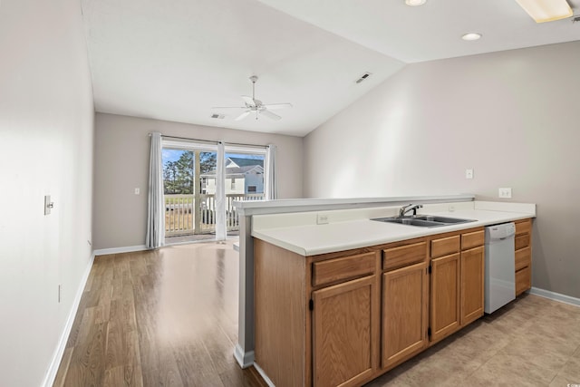 kitchen with vaulted ceiling, dishwasher, sink, and kitchen peninsula