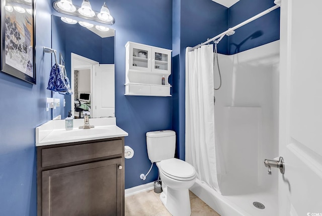 bathroom with toilet, vanity, tile patterned floors, and curtained shower