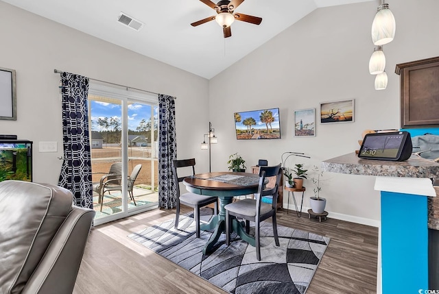 dining room featuring wood-type flooring, ceiling fan, and lofted ceiling