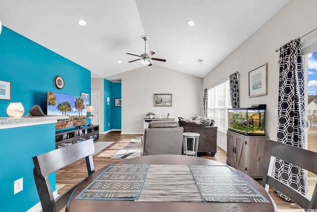 dining area featuring ceiling fan, hardwood / wood-style floors, and lofted ceiling