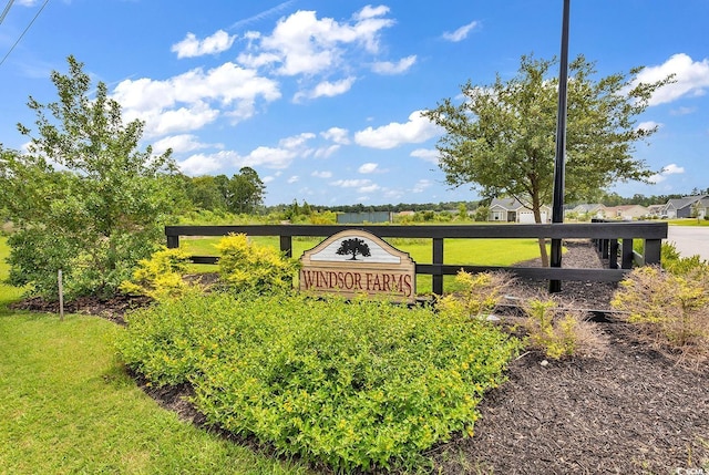 community / neighborhood sign with a lawn