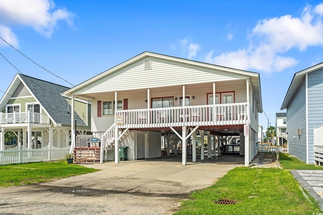 coastal home featuring a carport and covered porch