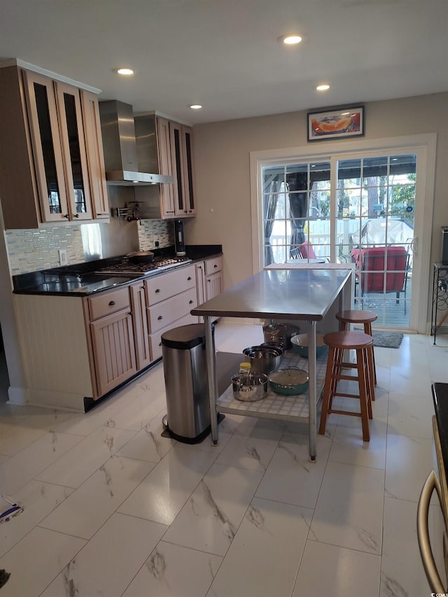 kitchen featuring tasteful backsplash, dark countertops, wall chimney range hood, and recessed lighting