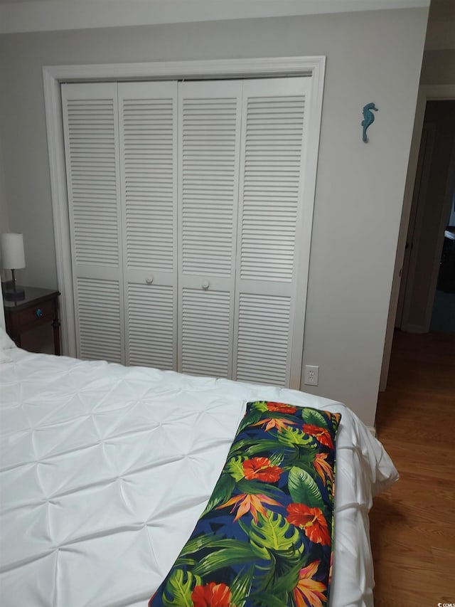 bedroom with a closet and wood finished floors