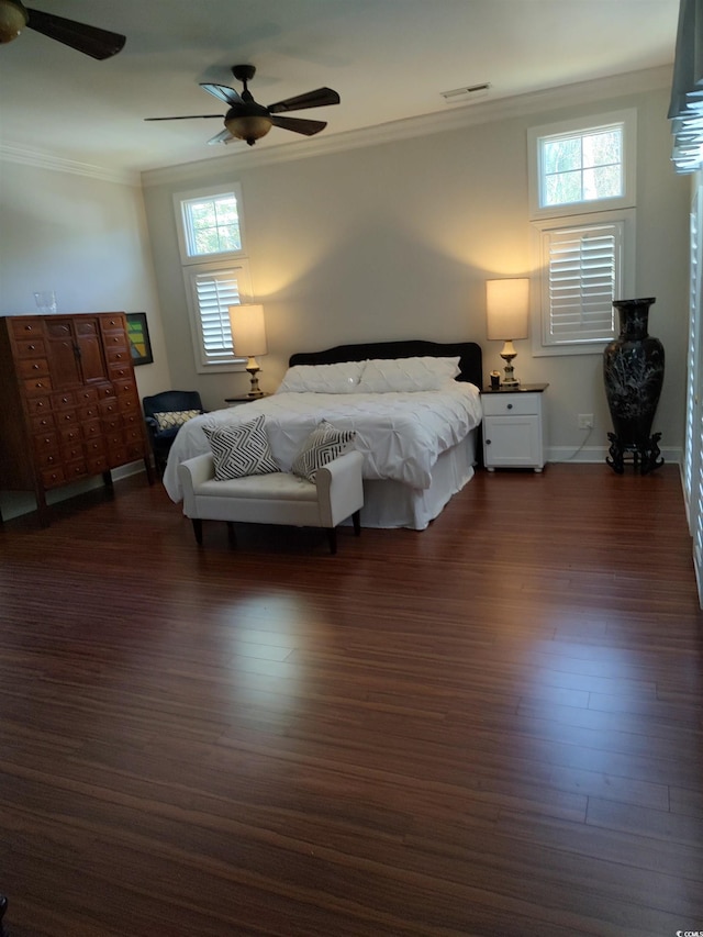 bedroom featuring ceiling fan, dark hardwood / wood-style flooring, and ornamental molding