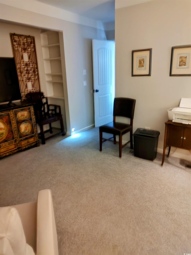 living area featuring built in features and light carpet