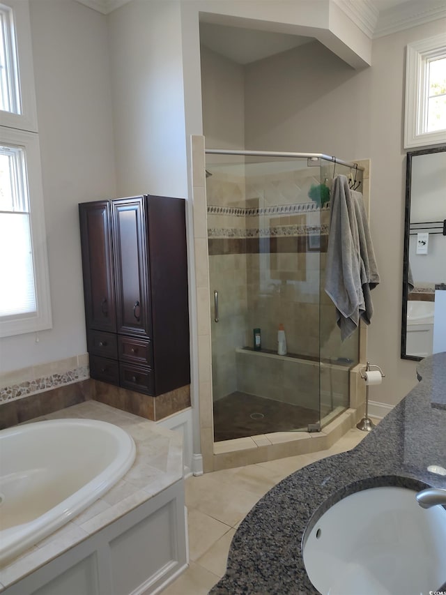 bathroom featuring tile patterned flooring, a sink, a shower stall, and a bath