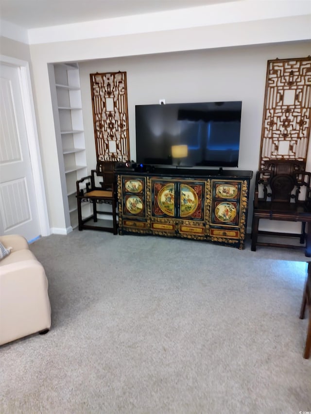 living area with carpet floors and baseboards