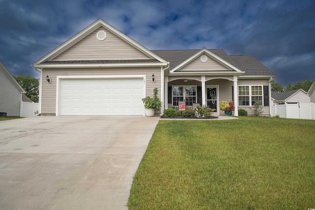 view of front of home featuring a porch, a garage, and a front lawn